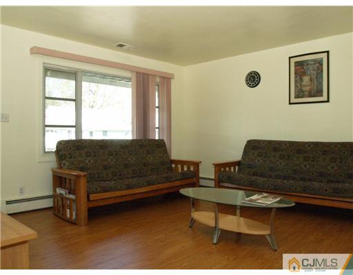 28 Stiles Road Edison, NJ 08817 - Photo 4 of 25 a living room with furniture and a window