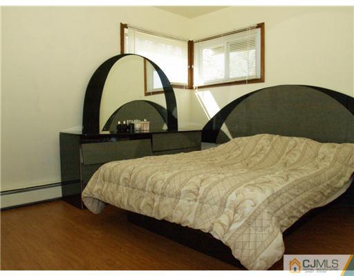 28 Stiles Road Edison, NJ 08817 - Photo 5 of 25 a bedroom with a bed and a large window