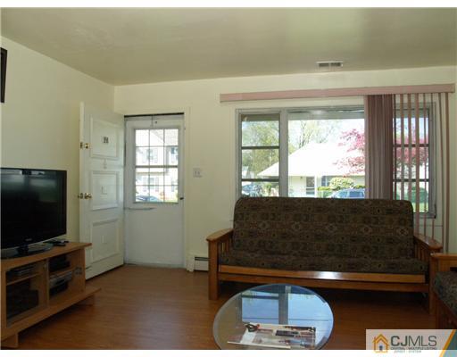 28 Stiles Road Edison, NJ 08817 - Photo 7 of 25 a living room with furniture and a flat screen tv