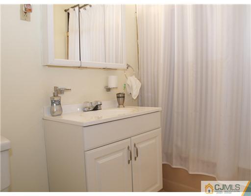 28 Stiles Road Edison, NJ 08817 - Photo 8 of 25 a bathroom with a sink and vanity