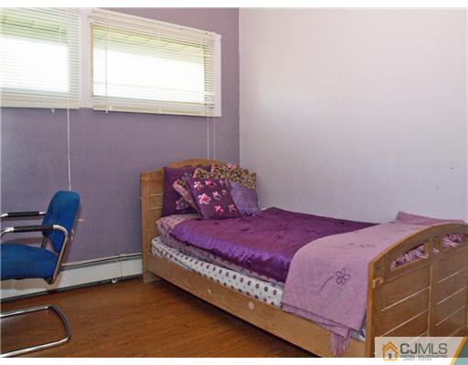 28 Stiles Road Edison, NJ 08817 - Photo 9 of 25 a bedroom with a bed and a window