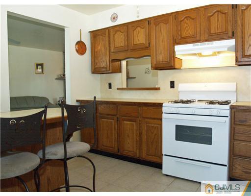 28 Stiles Road Edison, NJ 08817 - Photo 10 of 25 a kitchen with stainless steel appliances granite countertop a stove a sink dishwasher and a microwave oven with cabinets