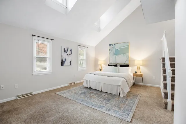 a bedroom with a large bed and a window