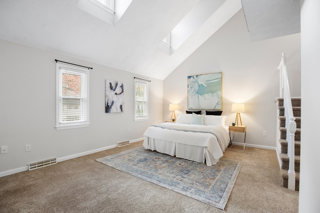 730 Wellman Avenue, Unit 730 Chelmsford, MA 01863 - Photo 14 of 31 a bedroom with a large bed and a window