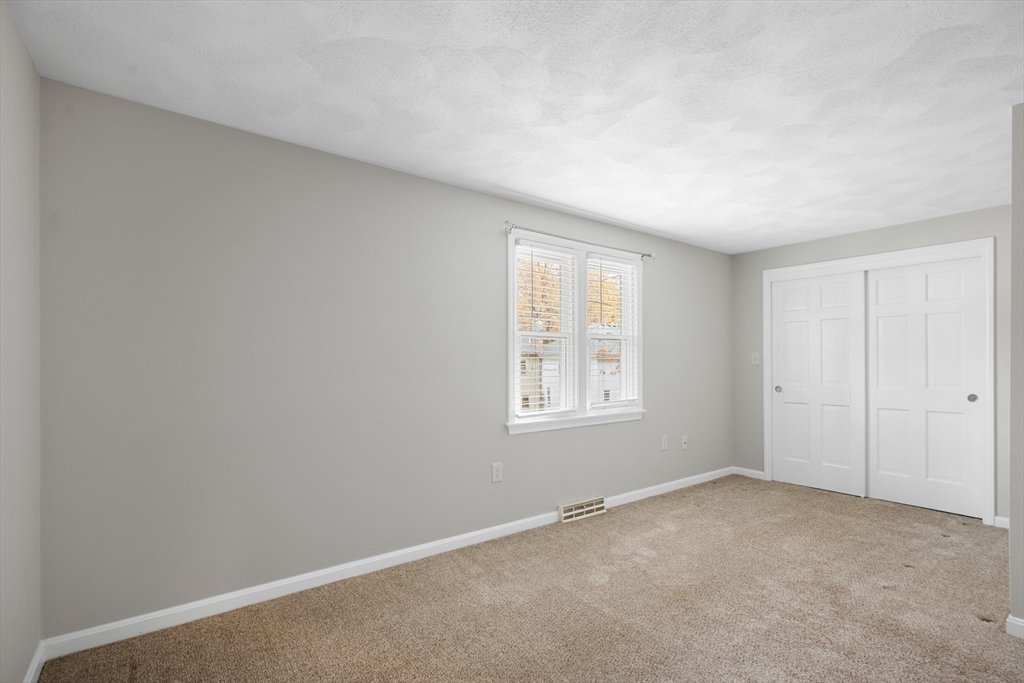 730 Wellman Avenue, Unit 730 Chelmsford, MA 01863 - Photo 22 of 31 an empty room with a window