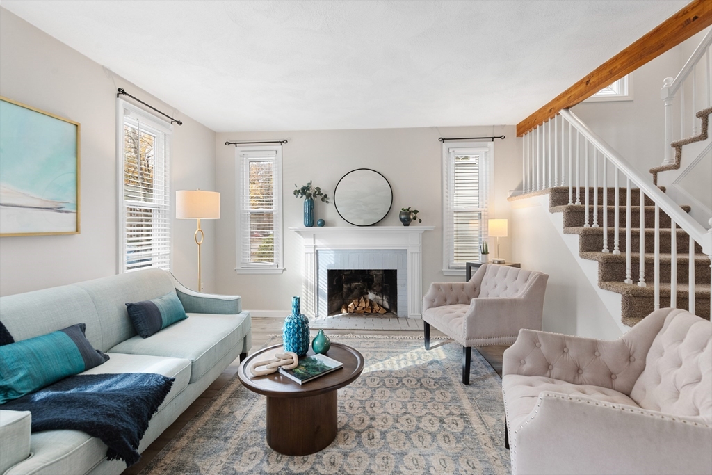 730 Wellman Avenue, Unit 730 Chelmsford, MA 01863 - Photo 3 of 31 a living room with furniture a fireplace and a large window