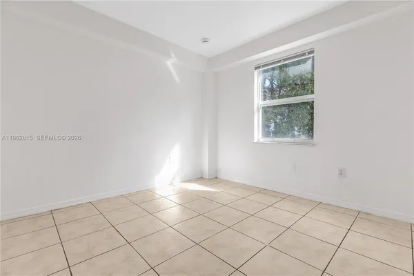 a view of a livingroom with an empty space and a window