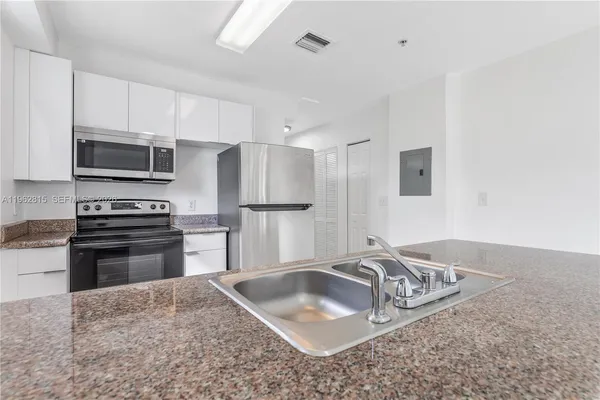 a kitchen with a sink and refrigerator