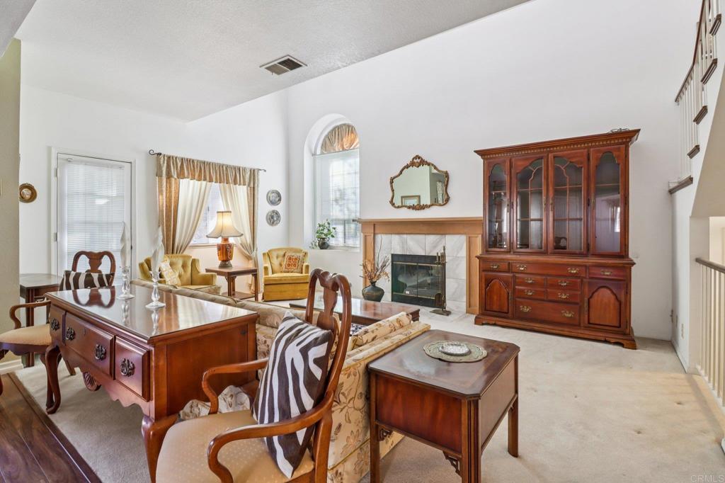 7747 Caminito Monarca, Unit 100 Carlsbad, CA 92009 - Photo 12 of 67 a living room with furniture and a fireplace