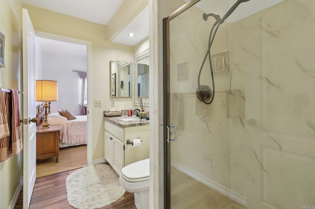 7747 Caminito Monarca, Unit 100 Carlsbad, CA 92009 - Photo 24 of 67 a spacious bathroom with a granite countertop sink a toilet and shower