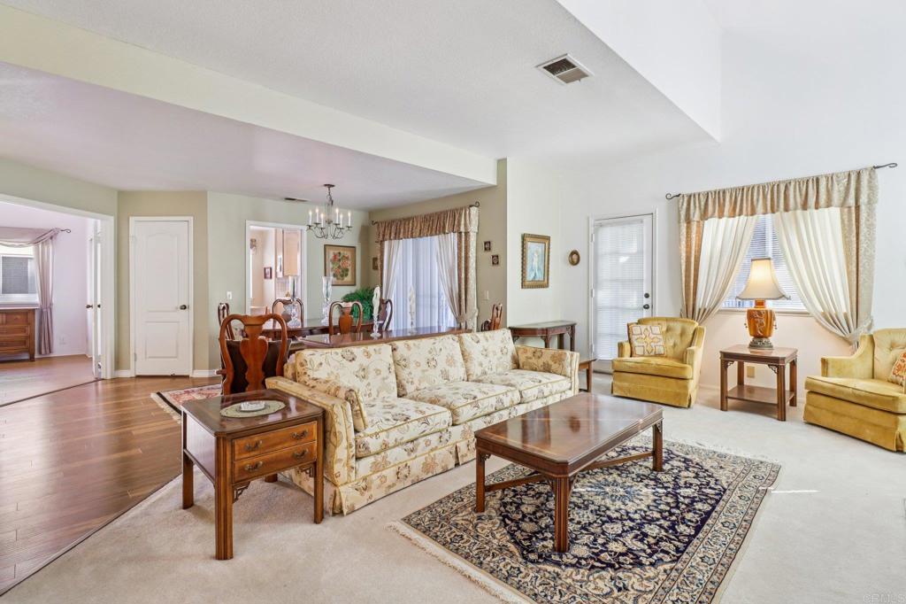7747 Caminito Monarca, Unit 100 Carlsbad, CA 92009 - Photo 6 of 67 a living room with furniture rug and window