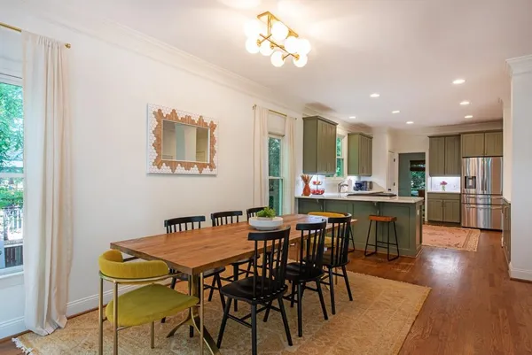 a living room with furniture and a view of kitchen