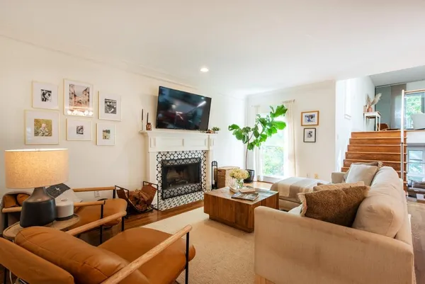 a living room with furniture and a potted plant