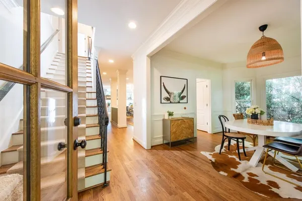 a view of a hallway with wooden floor and staircase