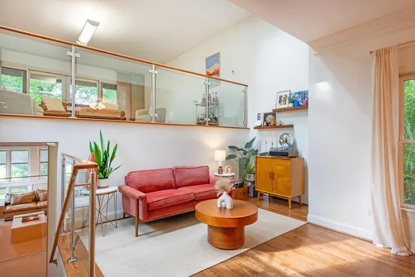 a living room with furniture and a floor to ceiling window