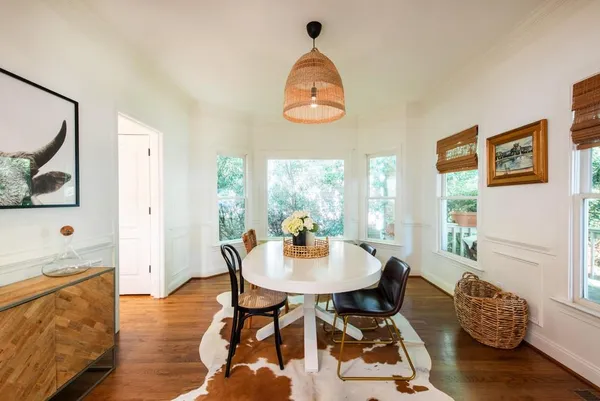a view of a dining room with furniture wooden floor and a chandelier