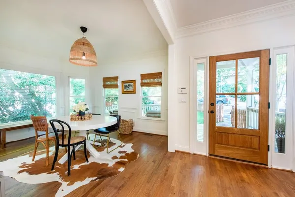 a view of a dining room with furniture and wooden floor