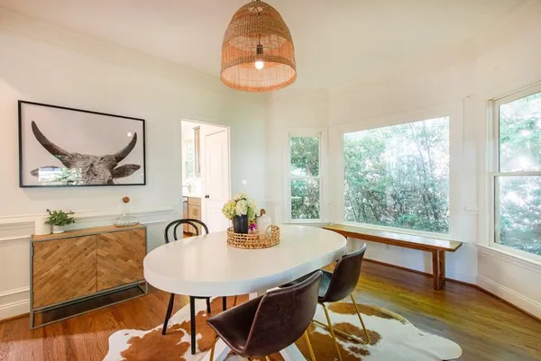 a view of a dining room with furniture and wooden floor