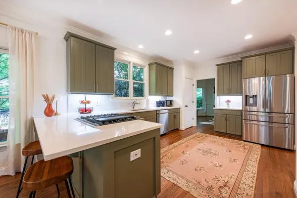 a kitchen with stainless steel appliances granite countertop a sink stove and cabinets