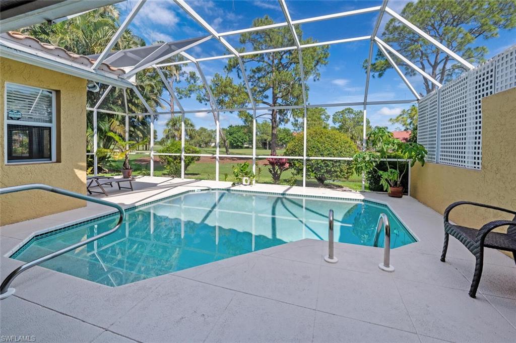 641 St Andrews Boulevard, Unit 1081 Naples, FL 34113 - Photo 1 of 31 a swimming pool with outdoor seating and yard