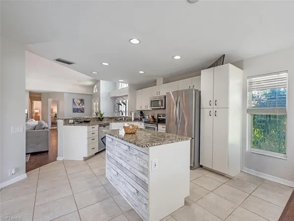 a bedroom with a bed table and a window