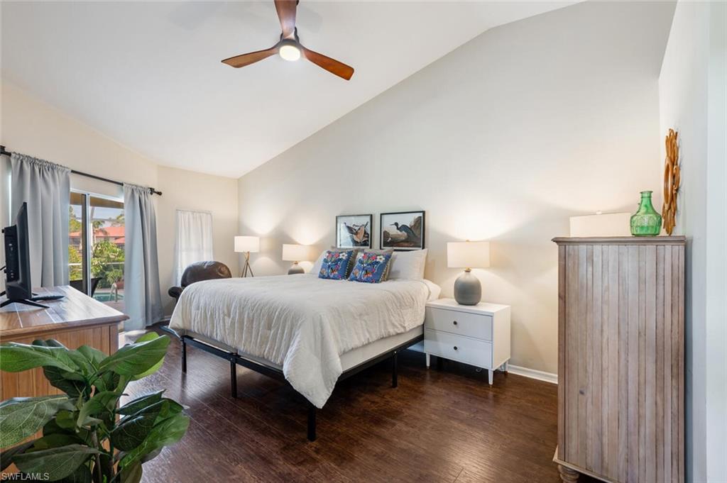641 St Andrews Boulevard, Unit 1081 Naples, FL 34113 - Photo 18 of 31 a bedroom with a bed table and a window