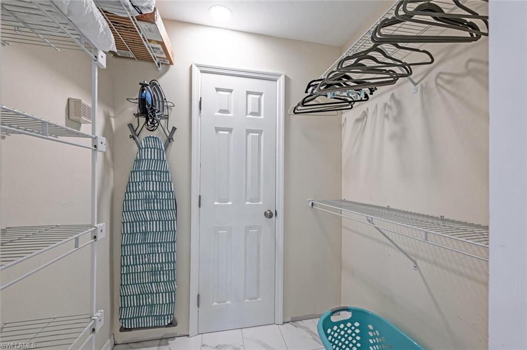 641 St Andrews Boulevard, Unit 1081 Naples, FL 34113 - Photo 22 of 31 a view of a walk in closet