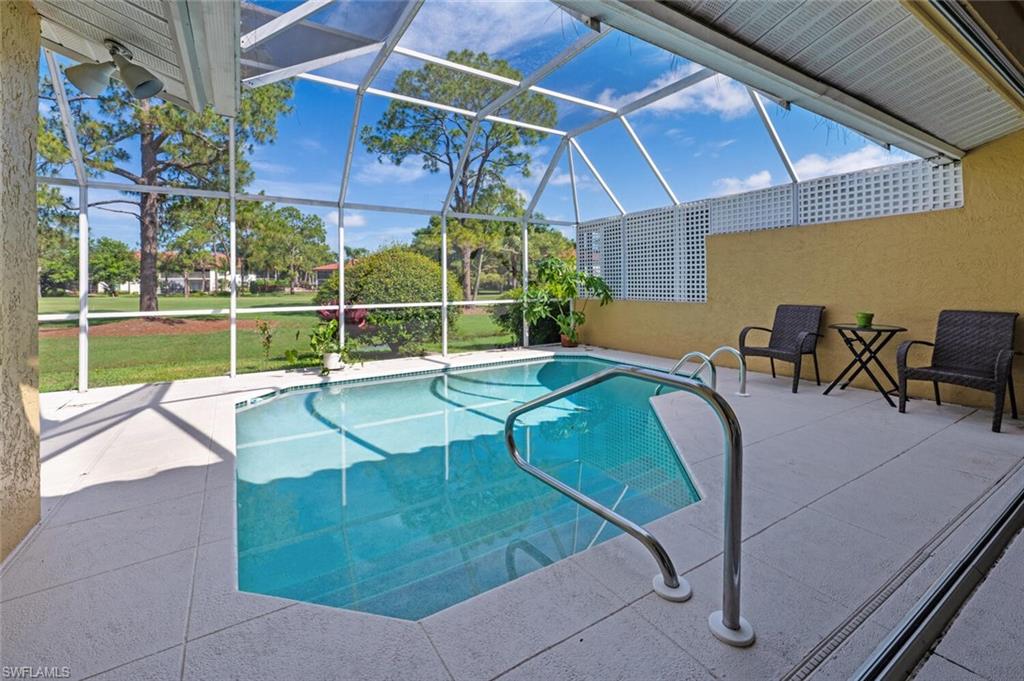 641 St Andrews Boulevard, Unit 1081 Naples, FL 34113 - Photo 27 of 31 a view of a swimming pool with a lounge chair