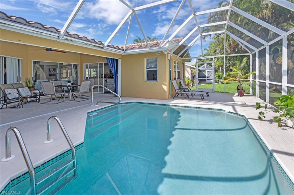 641 St Andrews Boulevard, Unit 1081 Naples, FL 34113 - Photo 28 of 31 a view of a swimming pool with outdoor seating