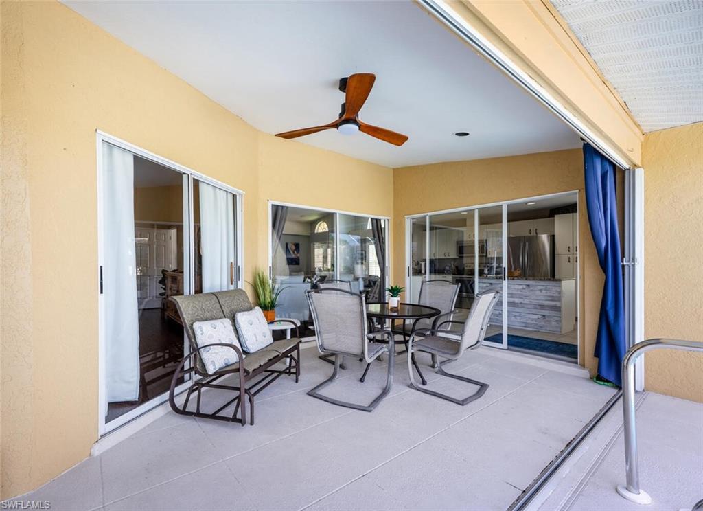 641 St Andrews Boulevard, Unit 1081 Naples, FL 34113 - Photo 30 of 31 a dining room with furniture and a window
