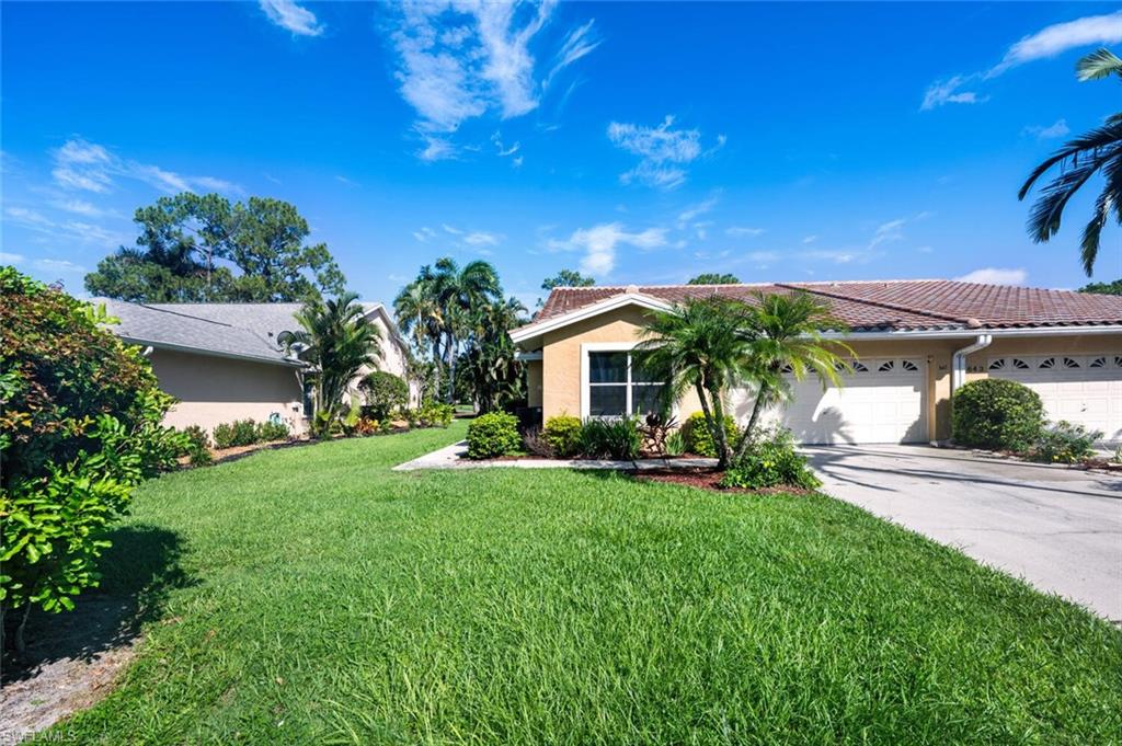 641 St Andrews Boulevard, Unit 1081 Naples, FL 34113 - Photo 3 of 31 a view of a house with a yard