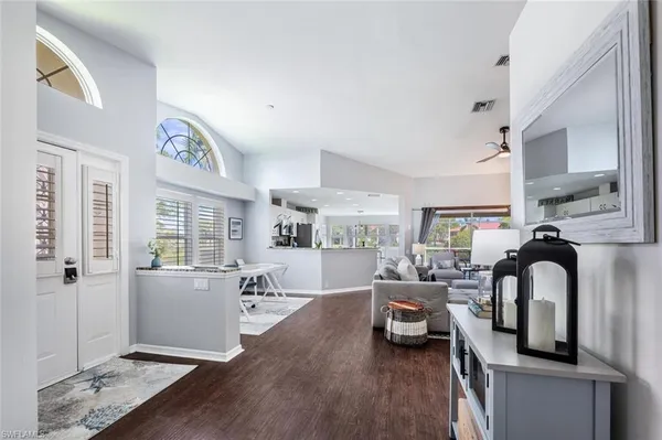 a living room with furniture and wooden floor