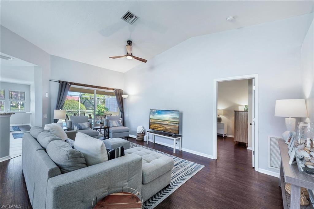641 St Andrews Boulevard, Unit 1081 Naples, FL 34113 - Photo 6 of 31 a living room with furniture and a wooden floor