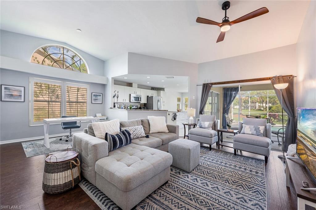 641 St Andrews Boulevard, Unit 1081 Naples, FL 34113 - Photo 7 of 31 a living room with furniture and a large window
