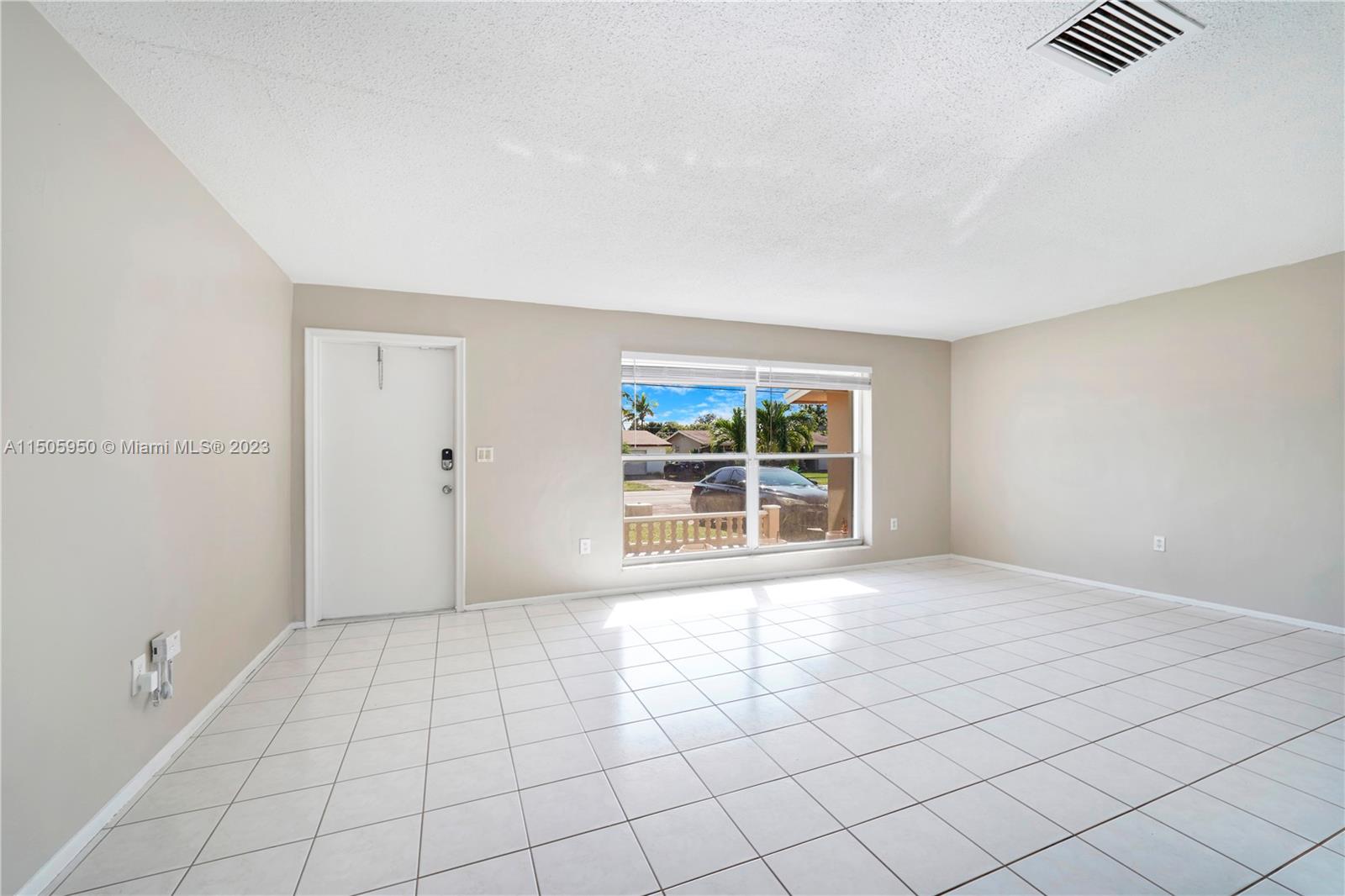8417 Northwest 25th Court Sunrise, FL 33322 - Photo 3 of 39 a view of an empty room with a window