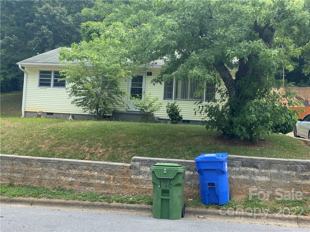 a view of a house with a yard porch and sitting area