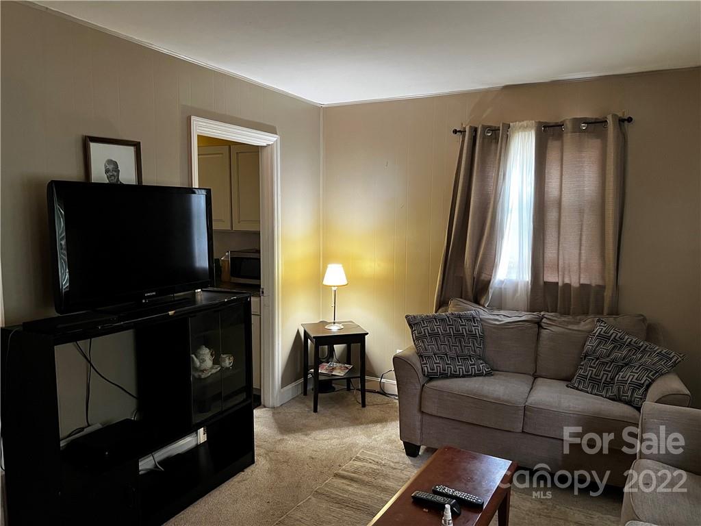 196 London Road Asheville, NC 28803 - Photo 2 of 14 a living room with furniture and a flat screen tv
