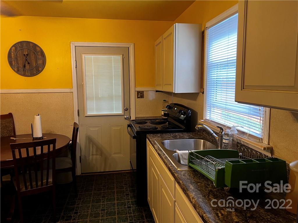 196 London Road Asheville, NC 28803 - Photo 5 of 14 a kitchen with a table and chairs