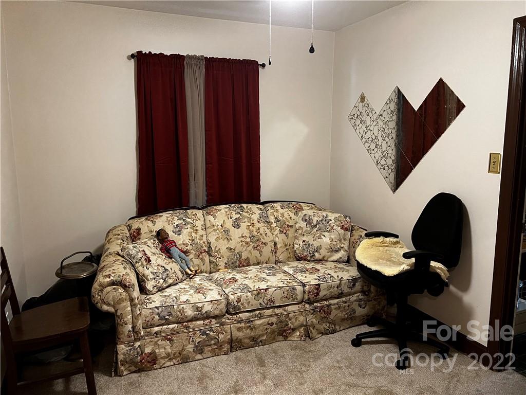 196 London Road Asheville, NC 28803 - Photo 7 of 14 a bedroom with a bed and a bookshelf