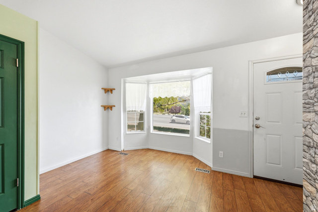 2475 Church Street Layton, UT 84040 - Photo 3 of 27 Bay window with white trim, wood-finish flooring, and white walls
