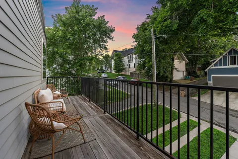 a view of balcony with wooden floor and outdoor seating