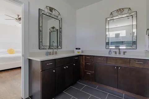 a bathroom with a double vanity sink mirror and