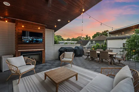 a outdoor living space with patio furniture and a fireplace