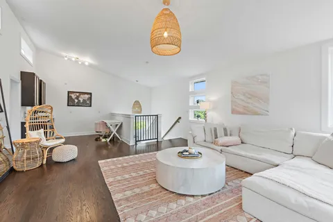 a living room with furniture and a dining table
