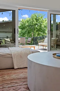 a living room with furniture and large windows