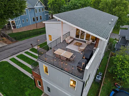 an aerial view of a house with a yard
