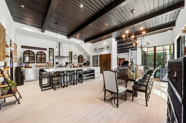 a large kitchen with stainless steel appliances a large counter top a stove a chimney a sink and cabinets