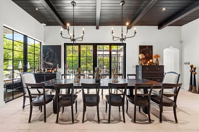 a living room with furniture a flat screen tv and floor to ceiling window