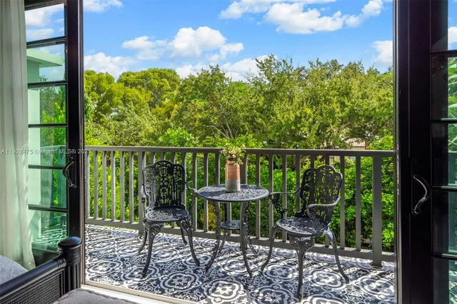 a bedroom with a bed dresser and a flat tv screen