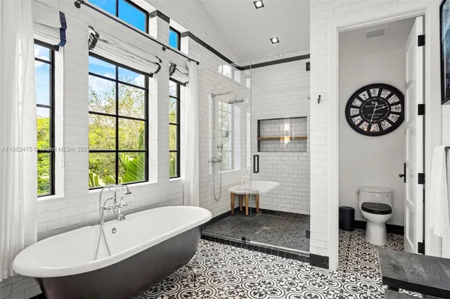 a view of a patio with a dining table and chairs with wooden floor